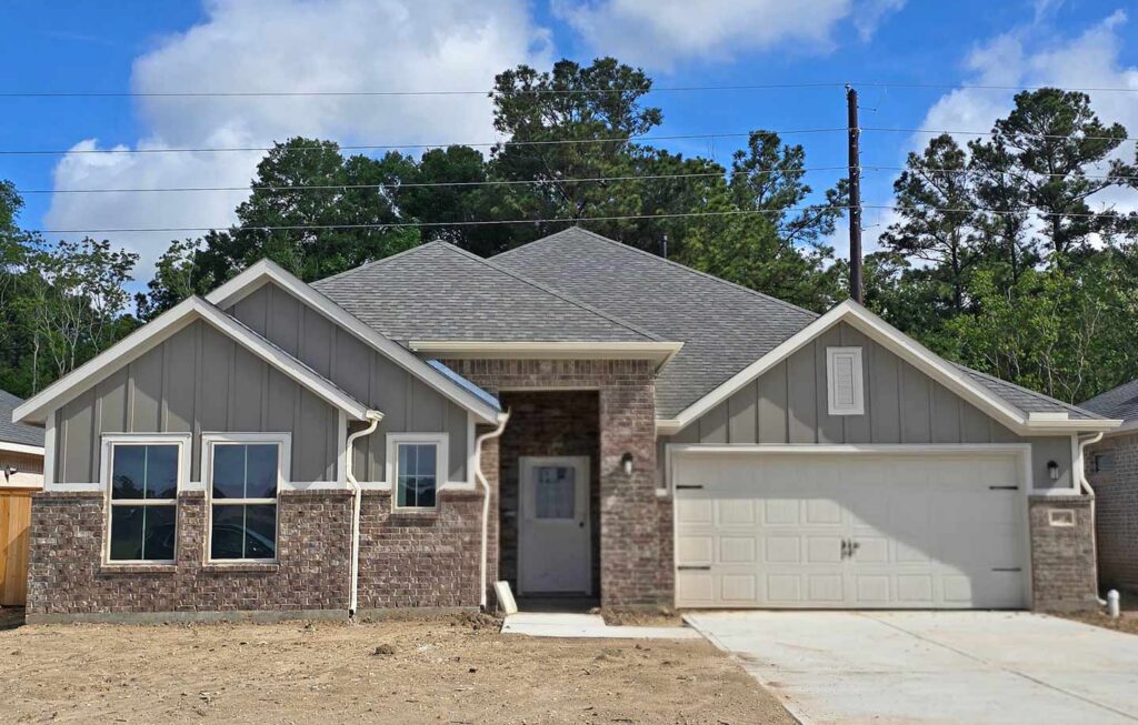 Built by Houston home builders Autograph Homes a single-story house with brick and siding exterior, and two-car garage.
