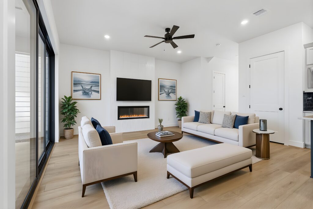 Modern living room by a top home builder in the Greater Houston area Autograph Homes with large windows and fireplace.